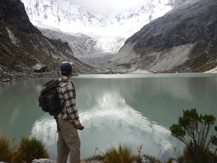 Pondering the glacial lake and the immense nevado.